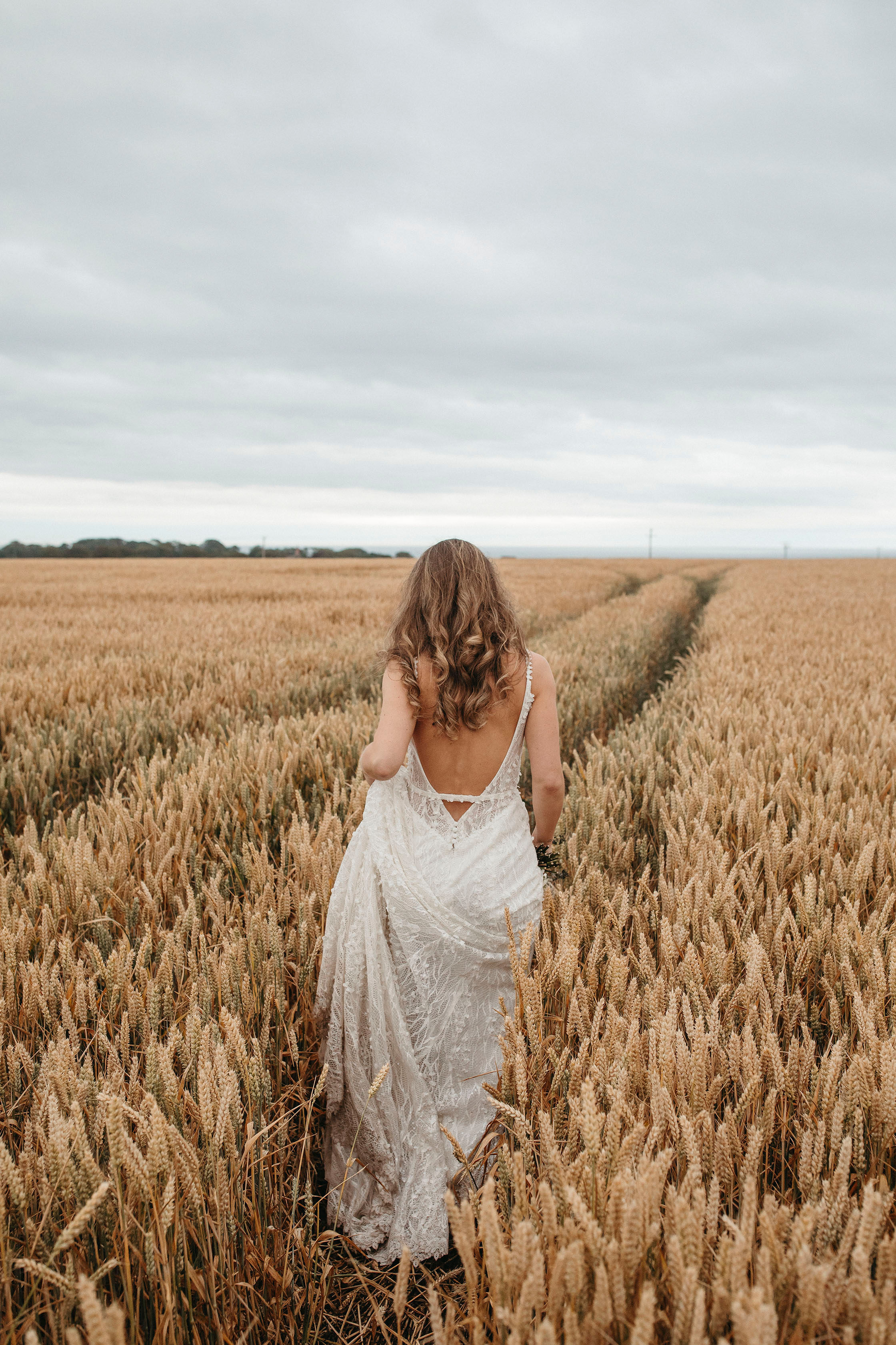 bride walking through fields in Fife
