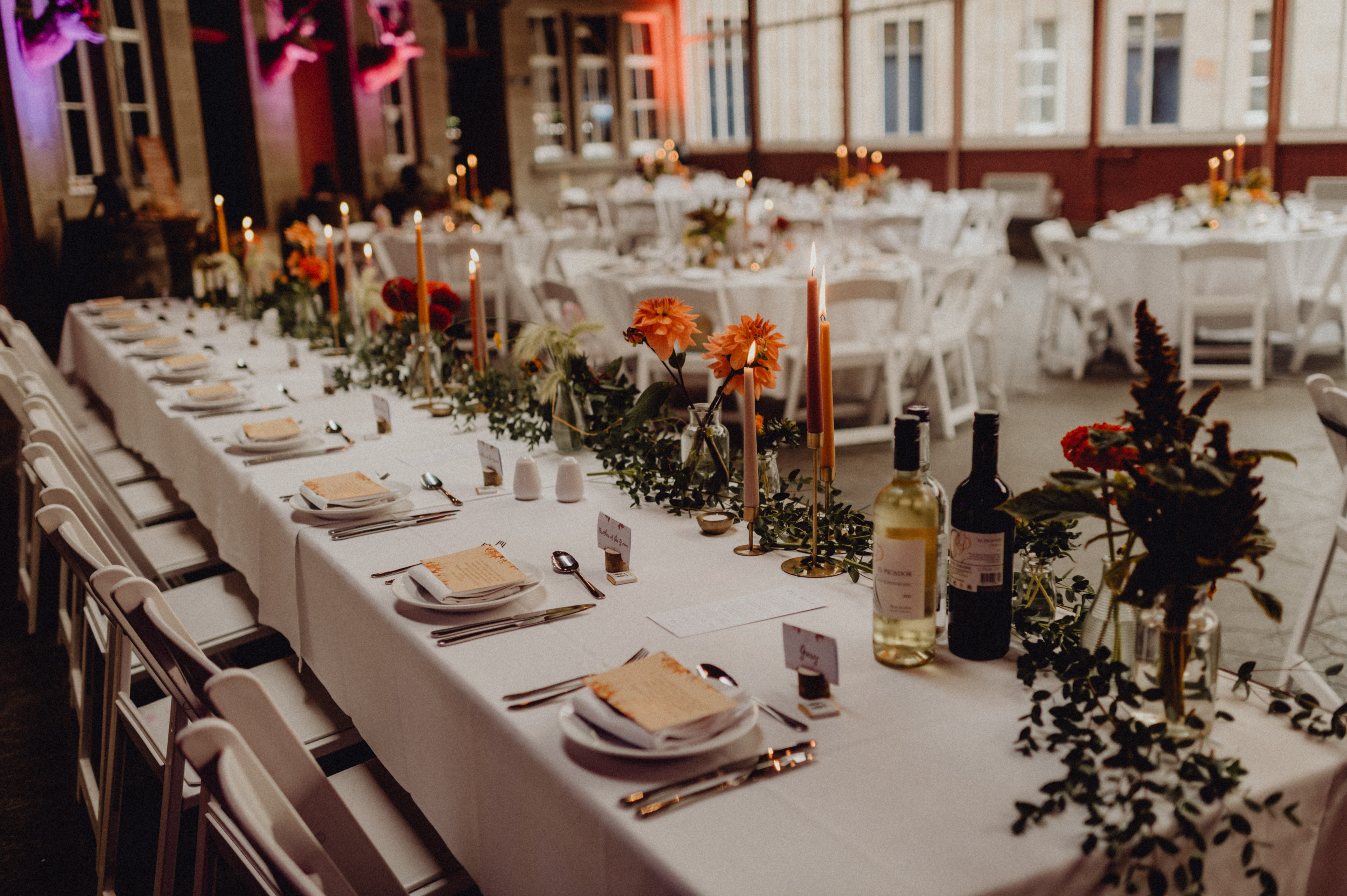 top table with bright flowers & dinner candles